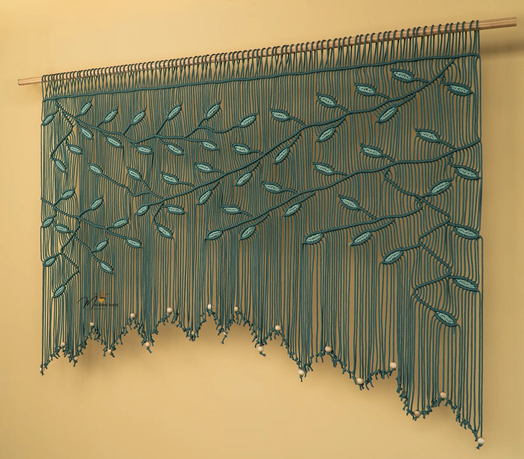 Decorative string curtain with leaf pattern on a beige background