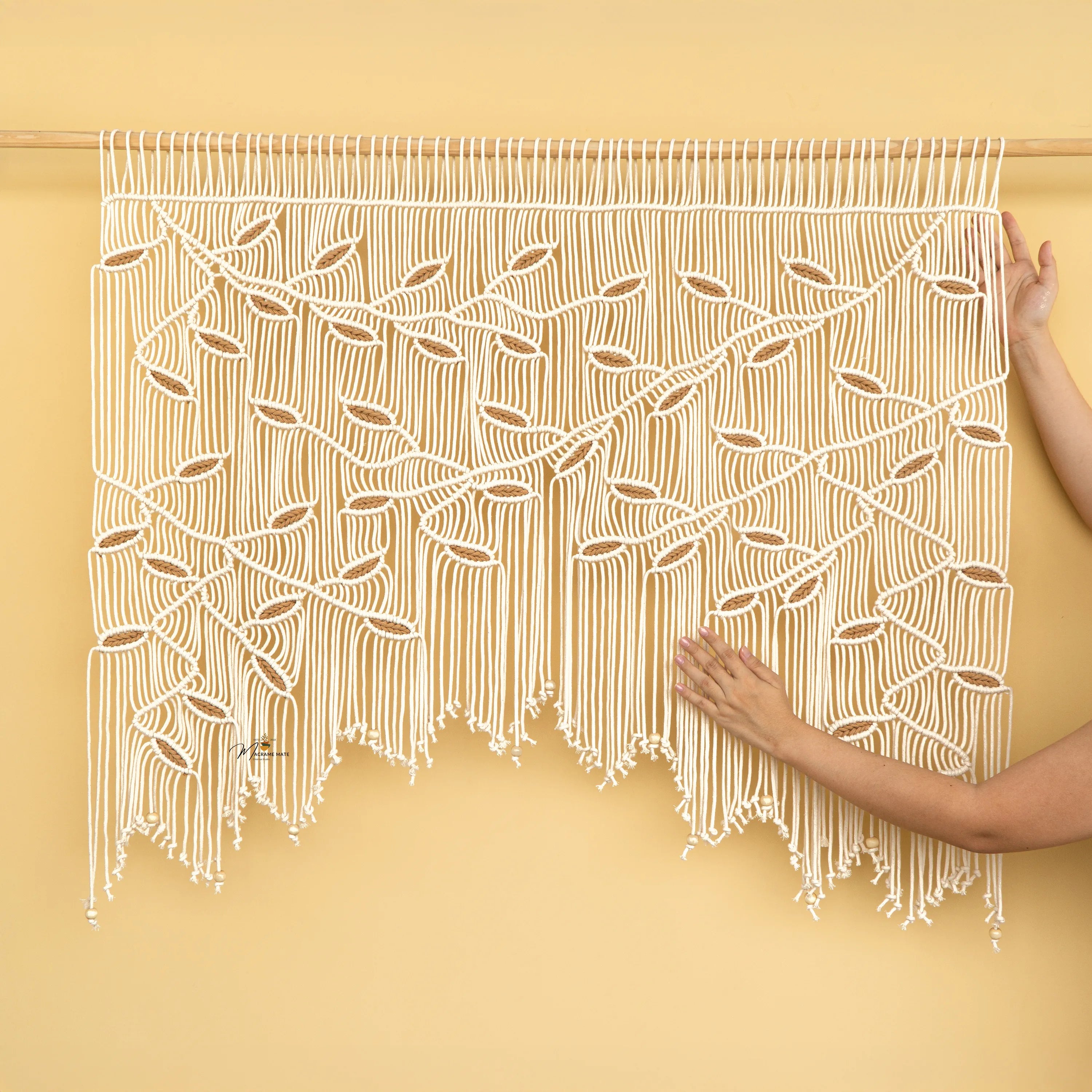 Macrame wall hanging with a geometric pattern on a yellow background