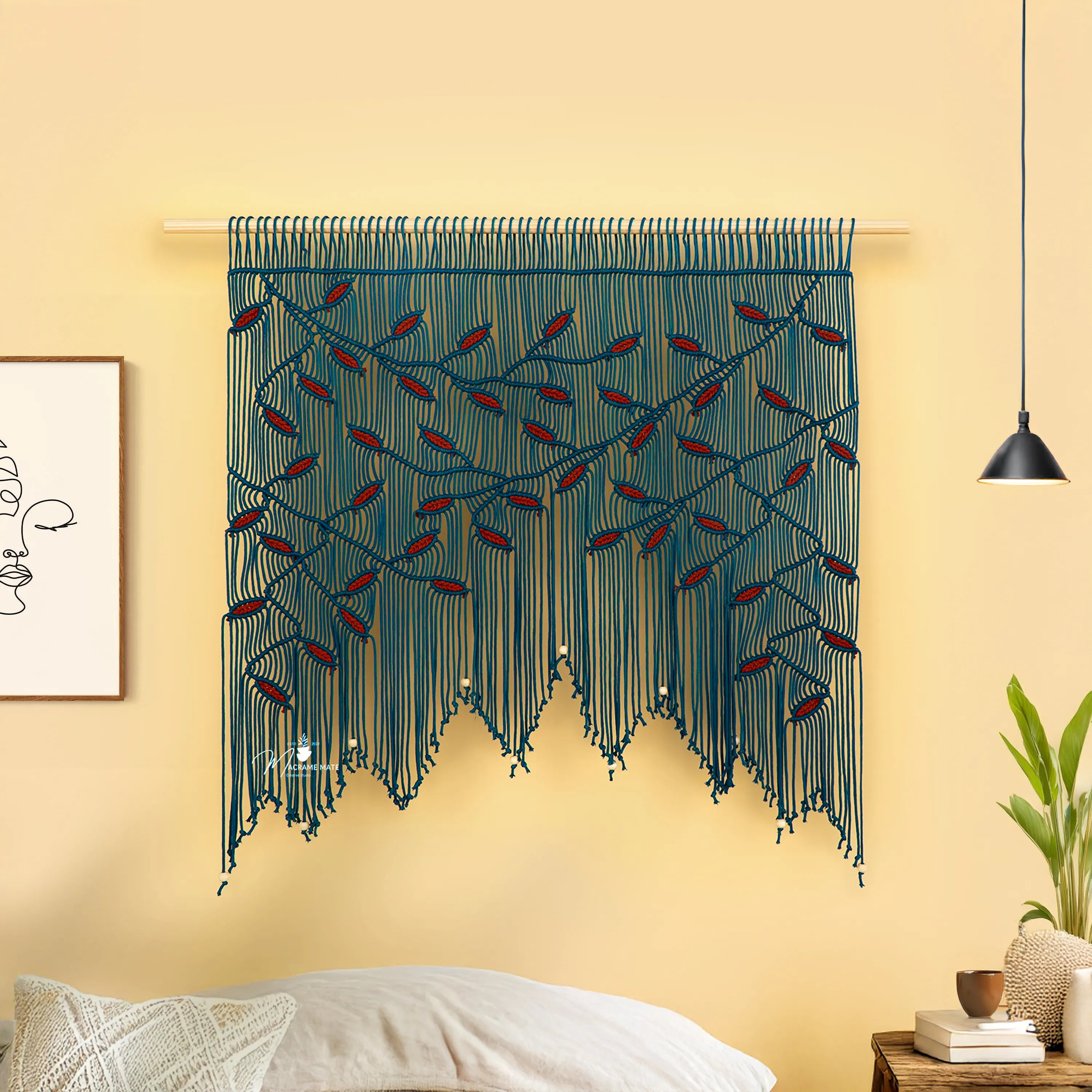 Decorative wall hanging with blue and red strings on a yellow wall.