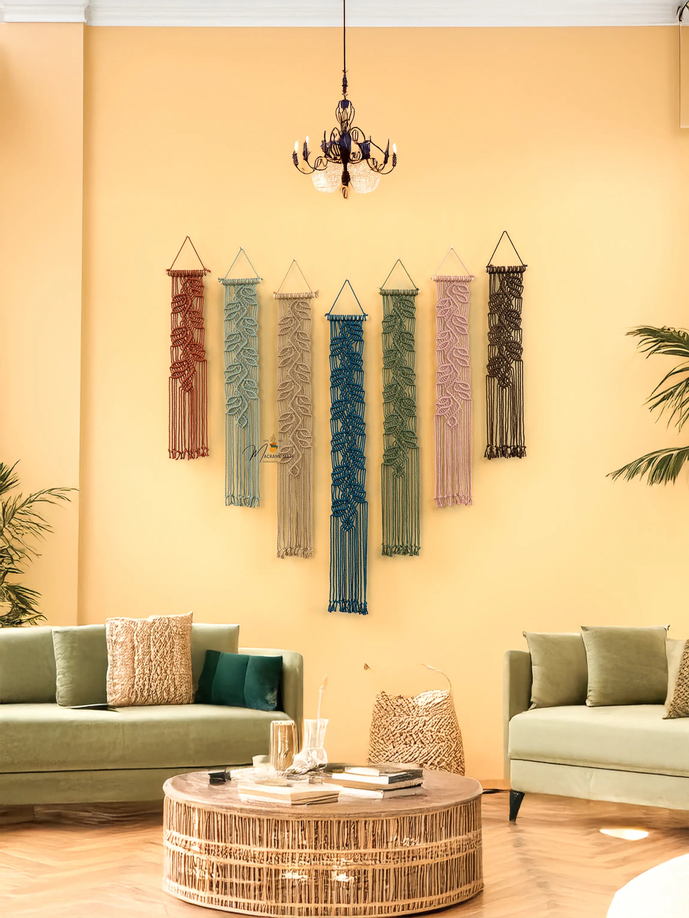 Living room with decorative wall hangings, green sofa, and wicker coffee table.