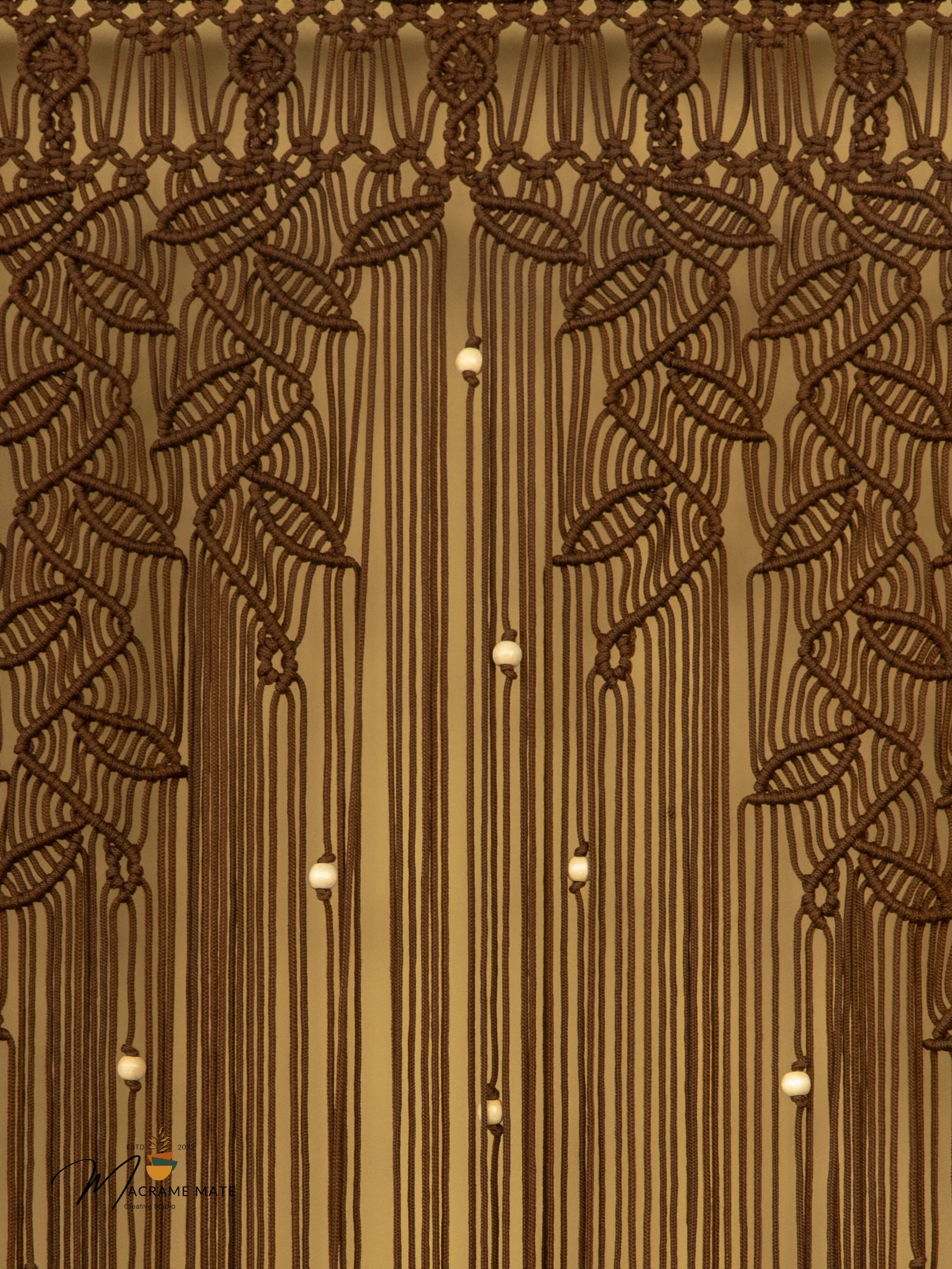 Decorative wall with intricate leaf patterns and hanging lights