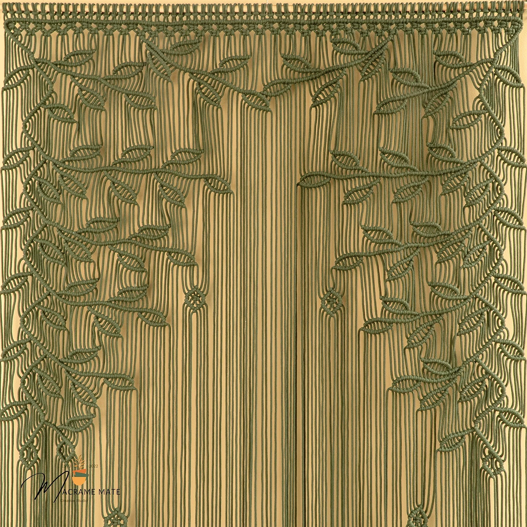 Decorative fabric swatch with leaf pattern on a beige background