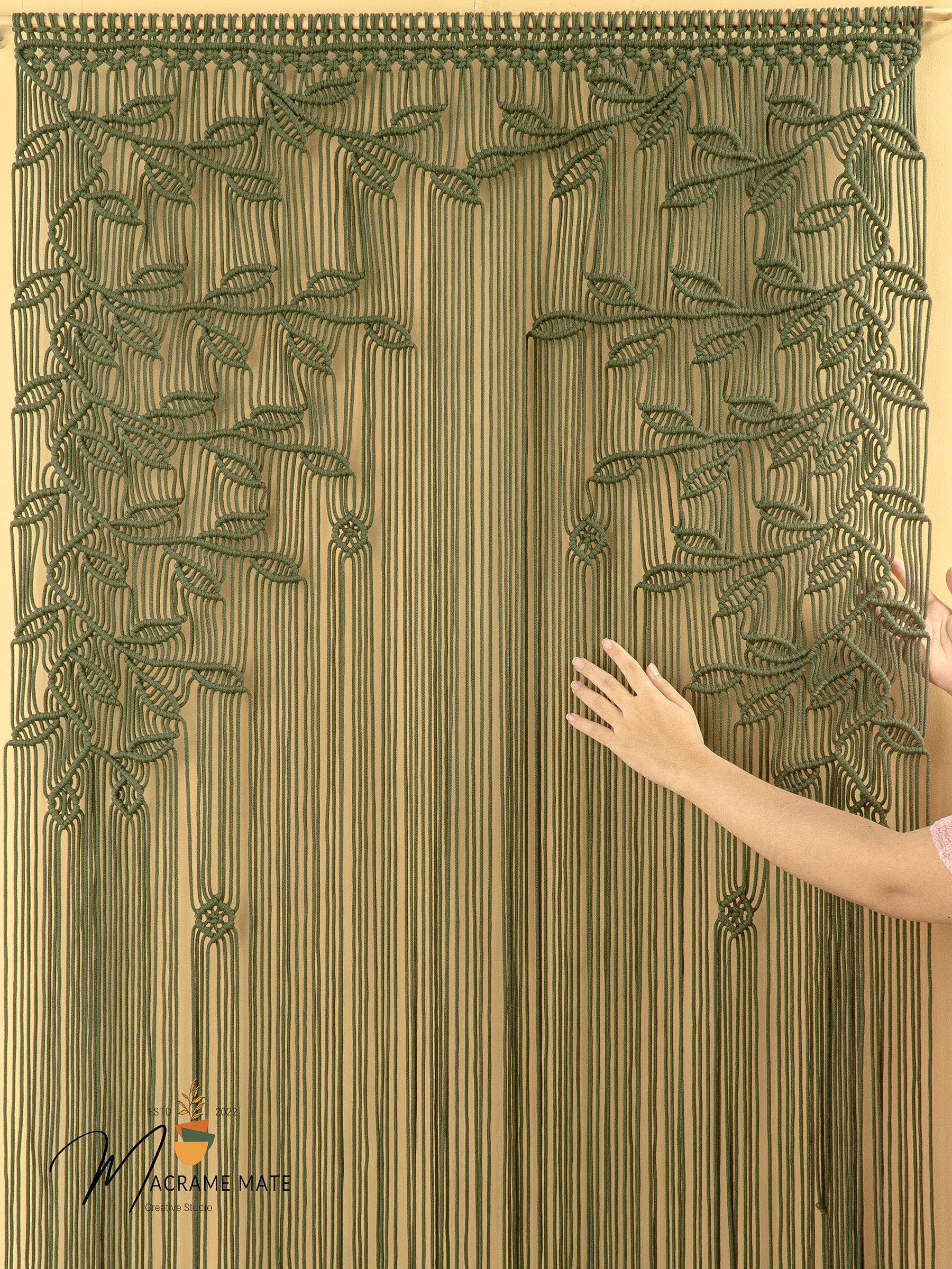 Textured curtain with leaf pattern and a hand touching it, brand 'Makromate' visible.