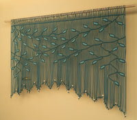 Decorative string curtain with leaf pattern on a beige background