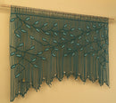 Decorative string curtain with leaf pattern on a beige background