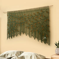 Decorative wall hanging with leaf pattern on a beige wall