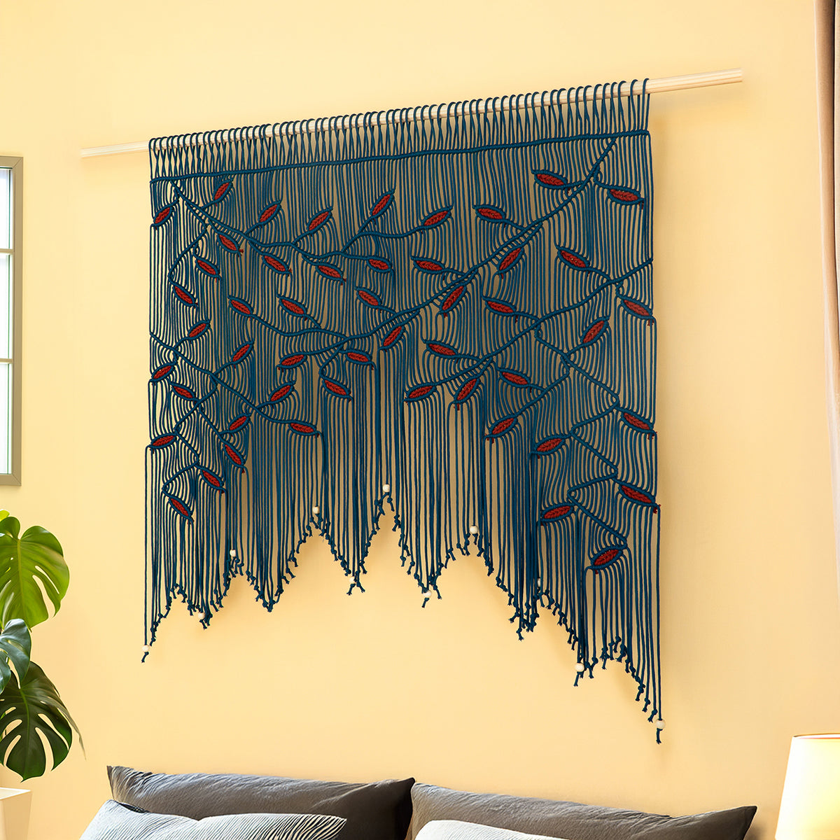 Decorative wall hanging with blue and red pattern on a yellow wall