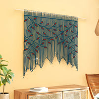 Decorative wall hanging with blue and red pattern on a yellow wall