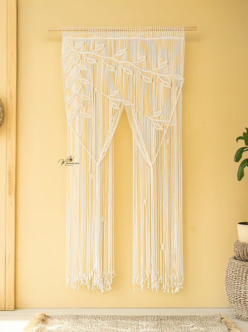 String art door curtain with leaf pattern on a yellow wall