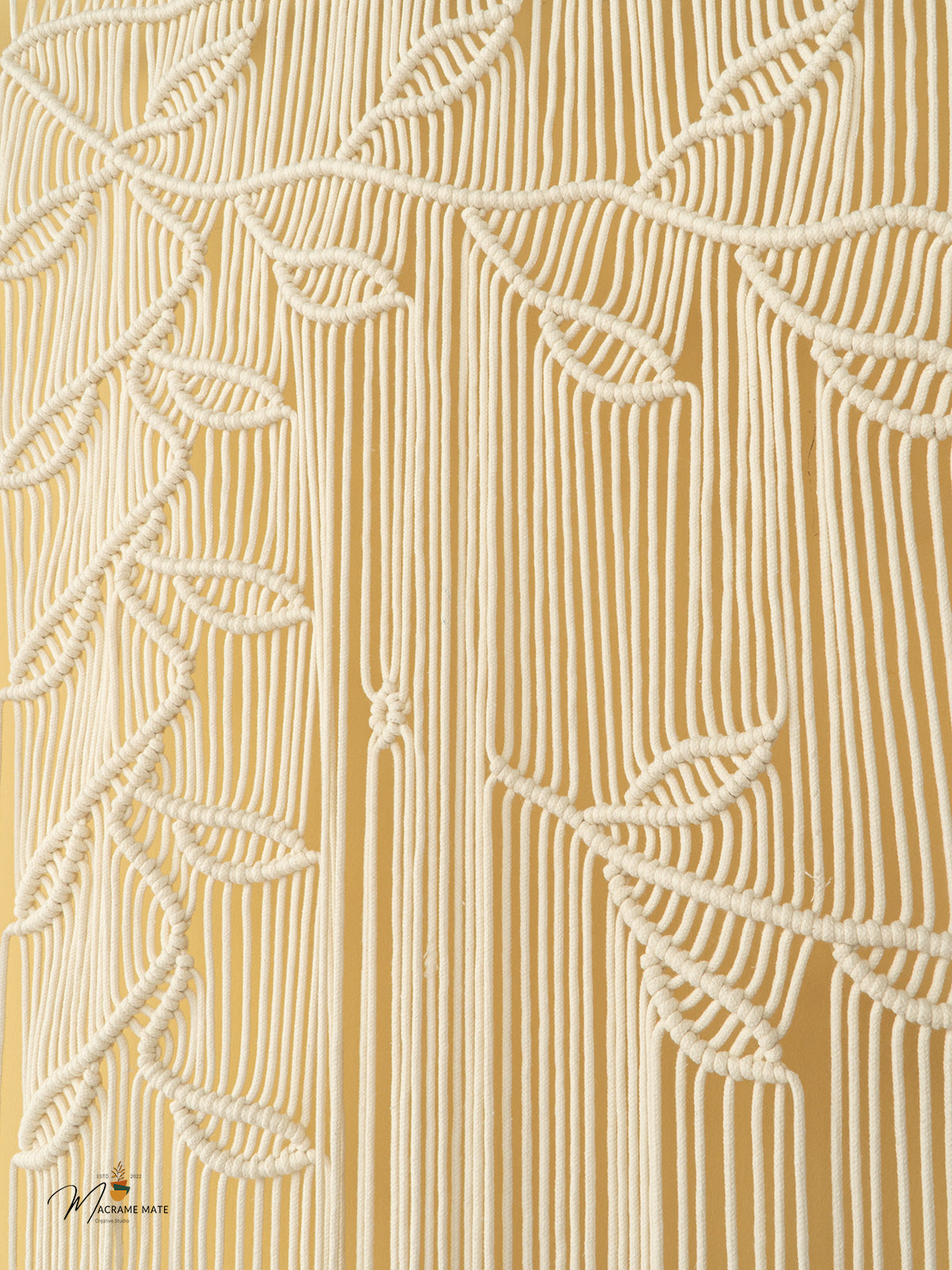 Close-up of a textured beige fabric with leaf patterns