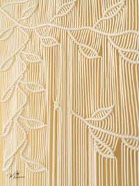 Close-up of a textured beige fabric with leaf patterns