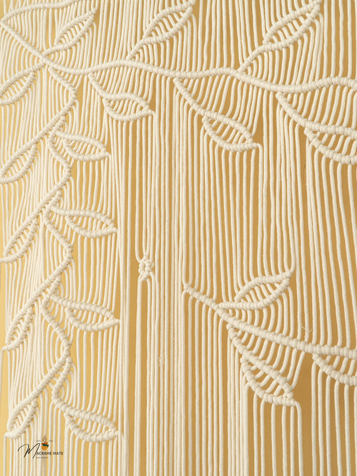 Close-up of a textured beige fabric with leaf patterns