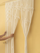 Decorative string curtain with leaf pattern against a yellow wall