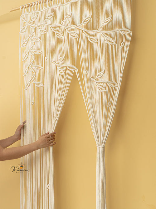 Decorative string curtain with leaf pattern against a yellow wall