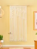 String art wall decoration on a yellow wall with a framed picture and plants.