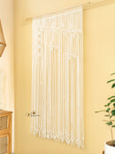 String curtain with leaf patterns on a yellow wall