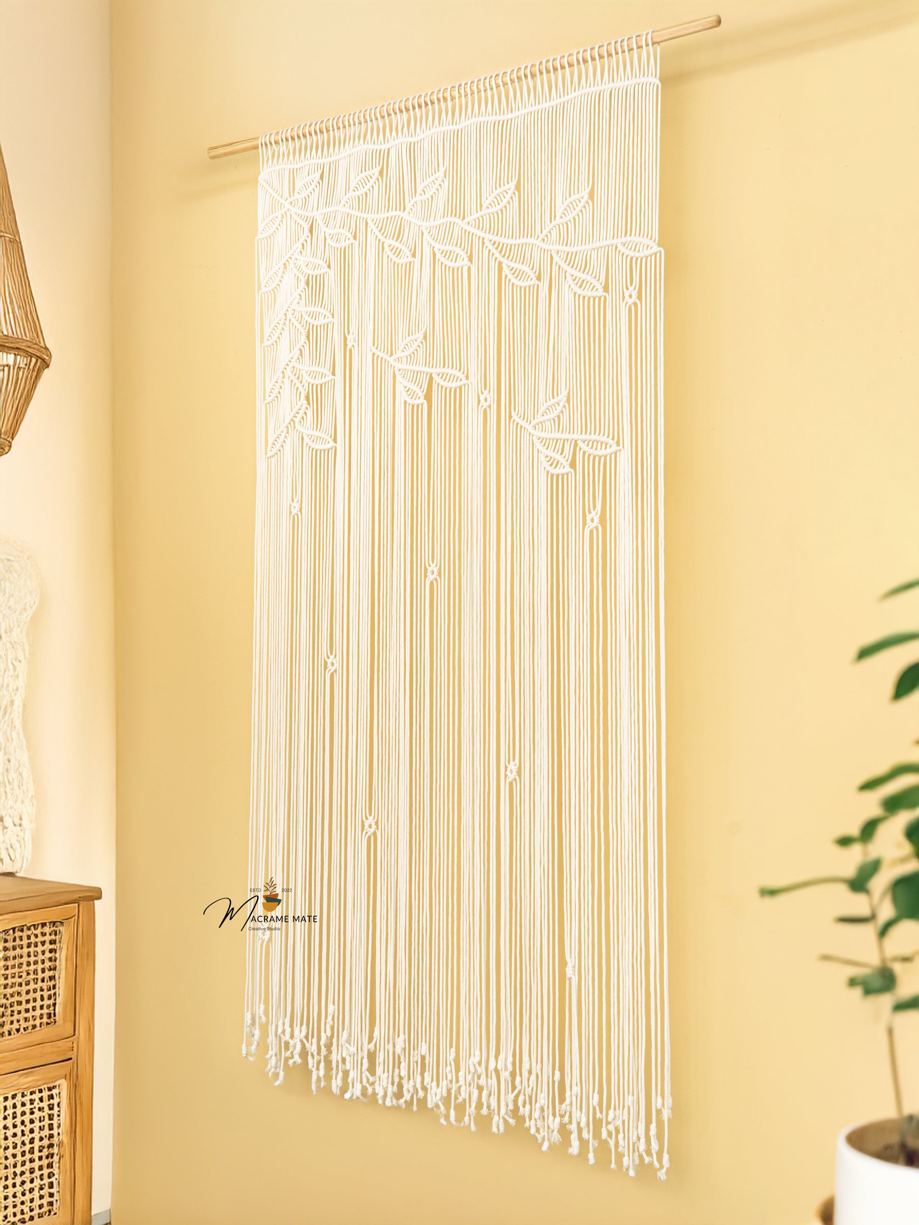 String curtain with leaf patterns on a yellow wall