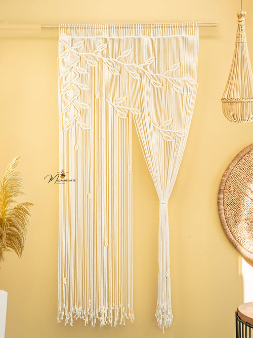 Macrame string art with leaf patterns on a yellow wall