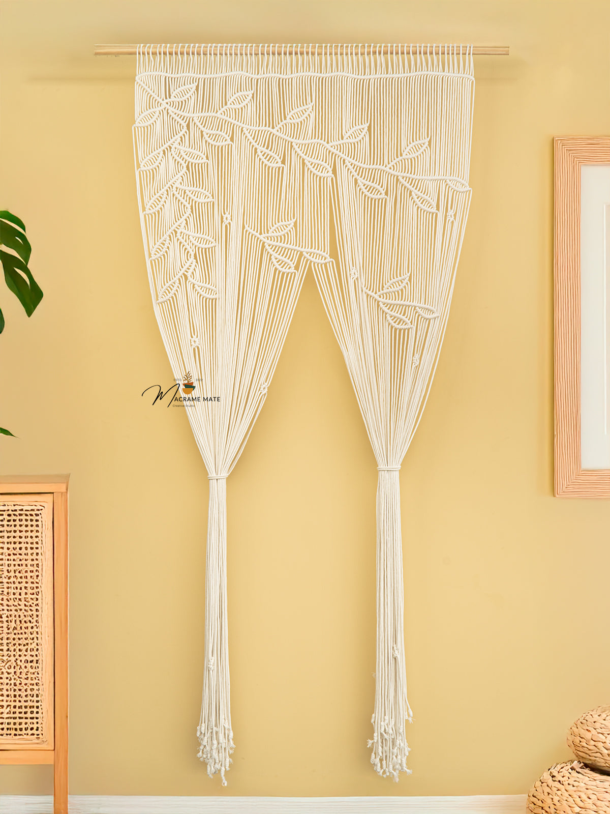 Macrame door curtain with leaf pattern on a yellow wall