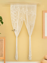 Macrame door curtain with leaf pattern on a yellow wall