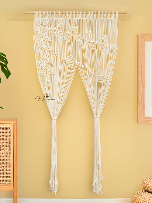 Macrame door curtain with leaf pattern on a yellow wall