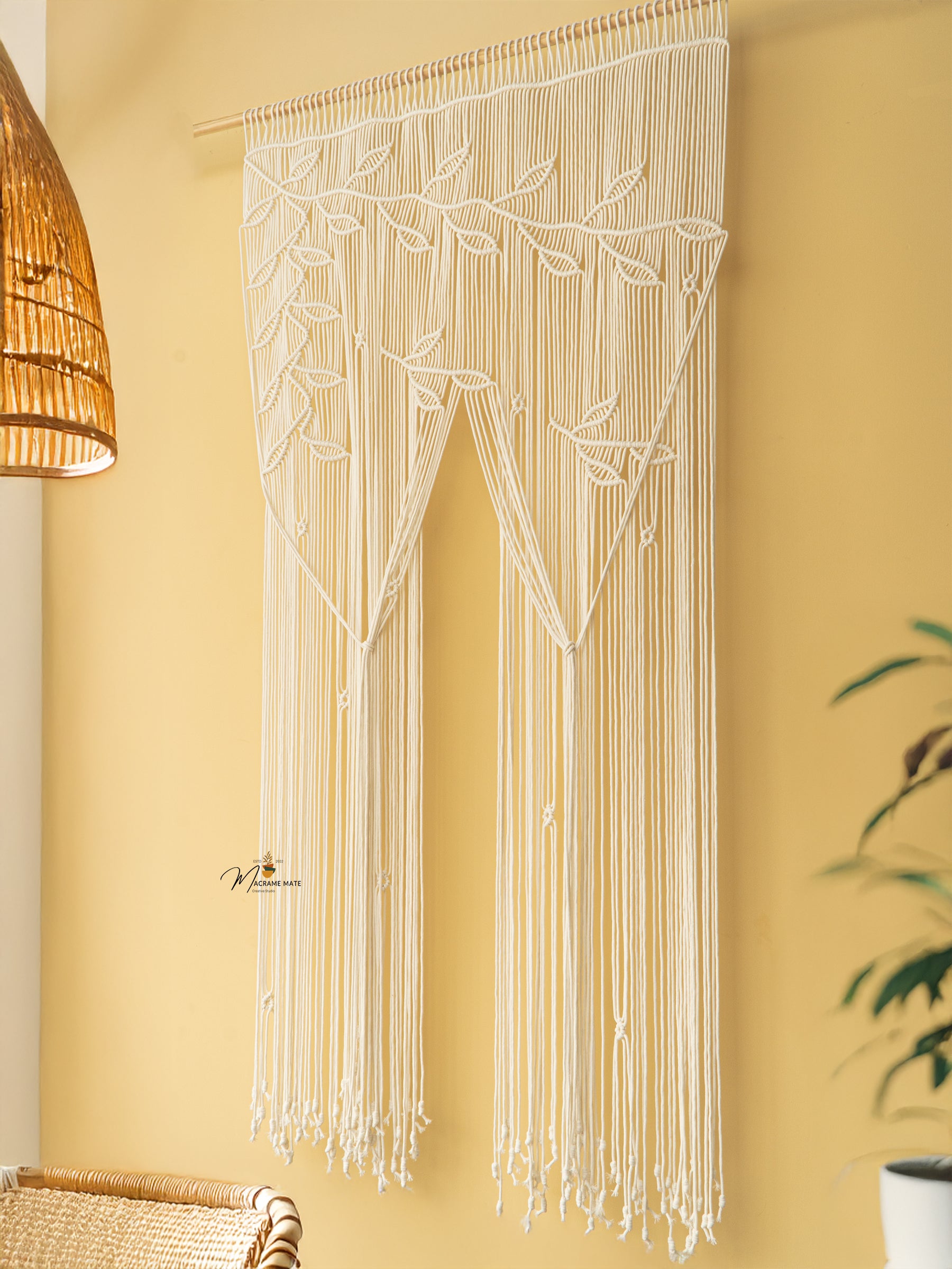 Macrame door hanging with leaf patterns on a yellow wall