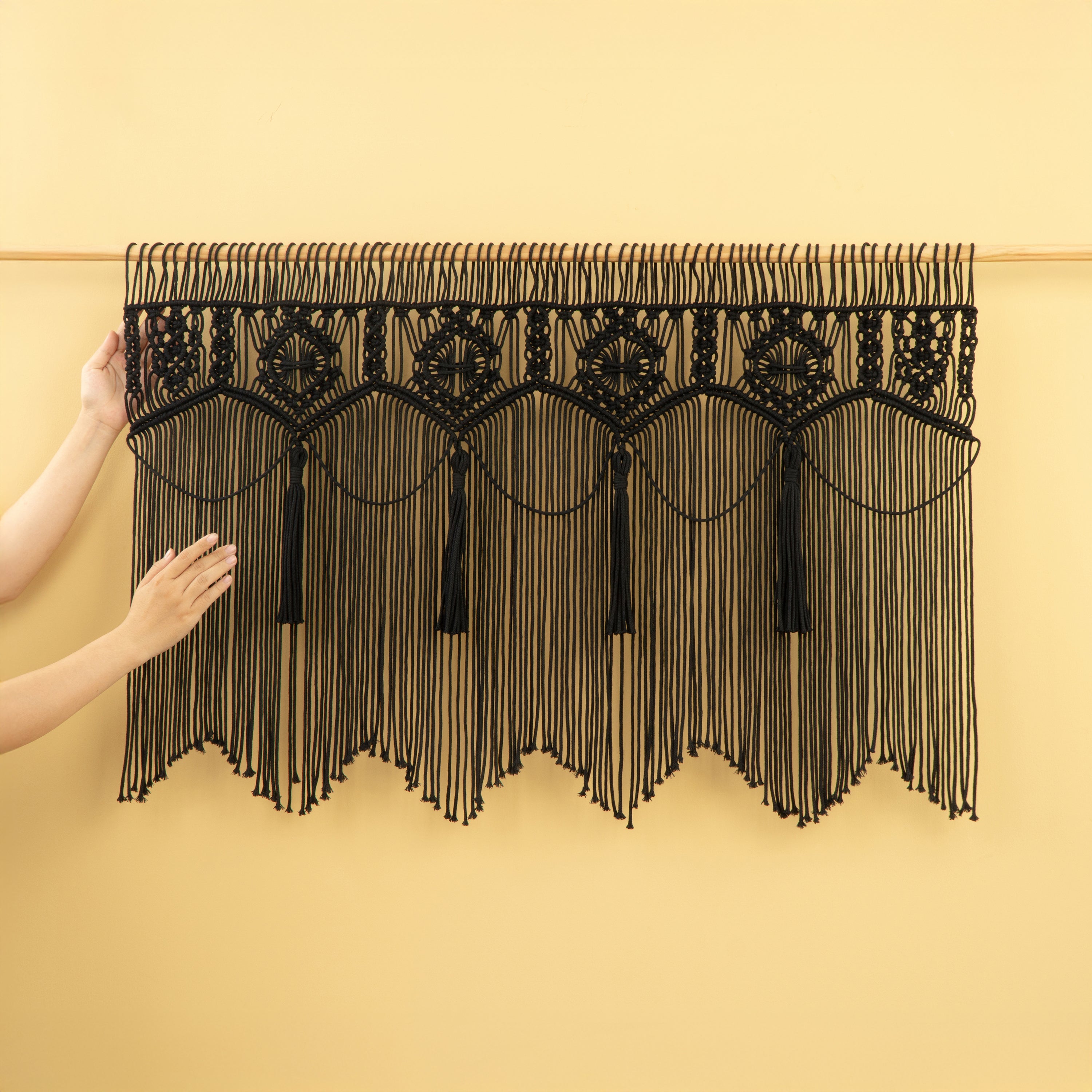 Black lace tablecloth with fringe on a yellow background