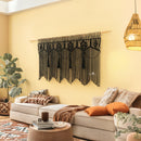 Living room with a decorative wall hanging, couch, and plants.