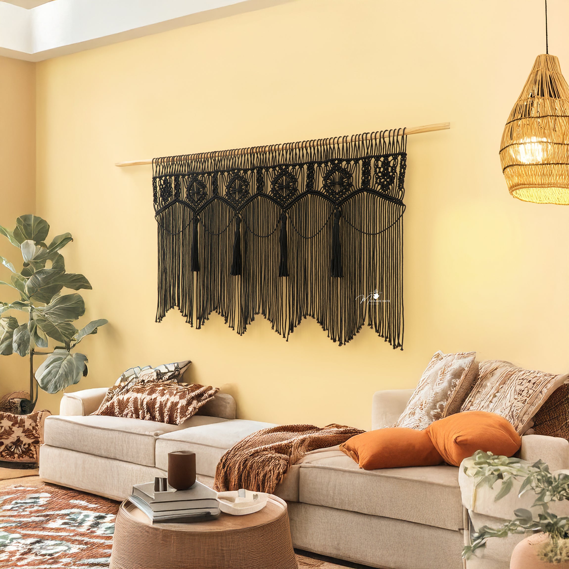 Living room with a decorative wall hanging, couch, and plants.