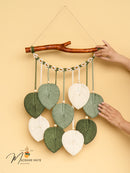 Macrame wall hanging with leaf-shaped decorations on a beige background, featuring the brand 'Macrame Mate'.