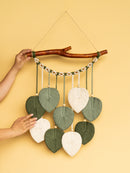 Decorative wall hanging with leaf-shaped leaves on a yellow background