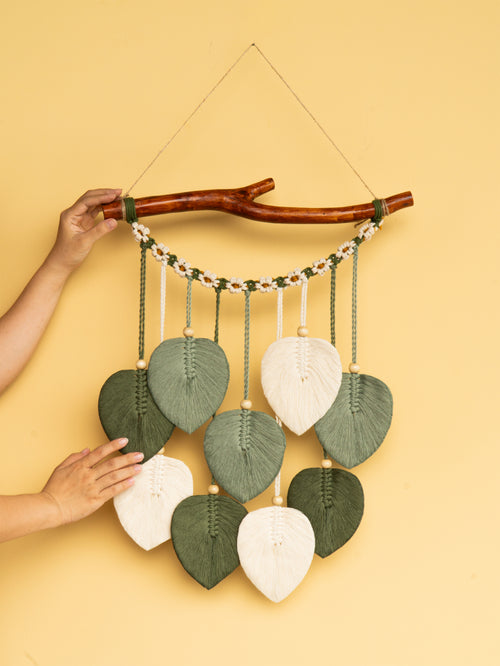 Decorative wall hanging with leaf-shaped leaves on a yellow background
