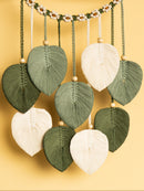 Decorative leaf-shaped ornaments hanging against a yellow background