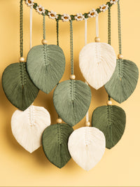 Decorative leaf-shaped ornaments hanging against a yellow background