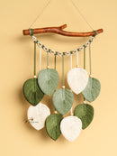 Decorative wall hanging with leaf-shaped ornaments on a beige background