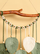 Decorative wall hanging with natural elements on a beige background