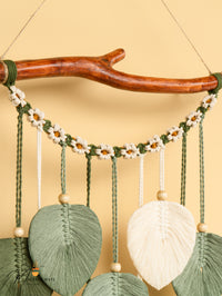 Decorative wall hanging with natural elements on a beige background