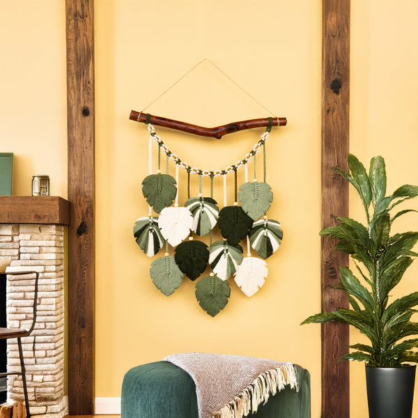 Decorative wall hanging with leaf patterns on a yellow wall