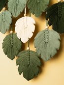 Decorative leaf tassel garland on a beige background