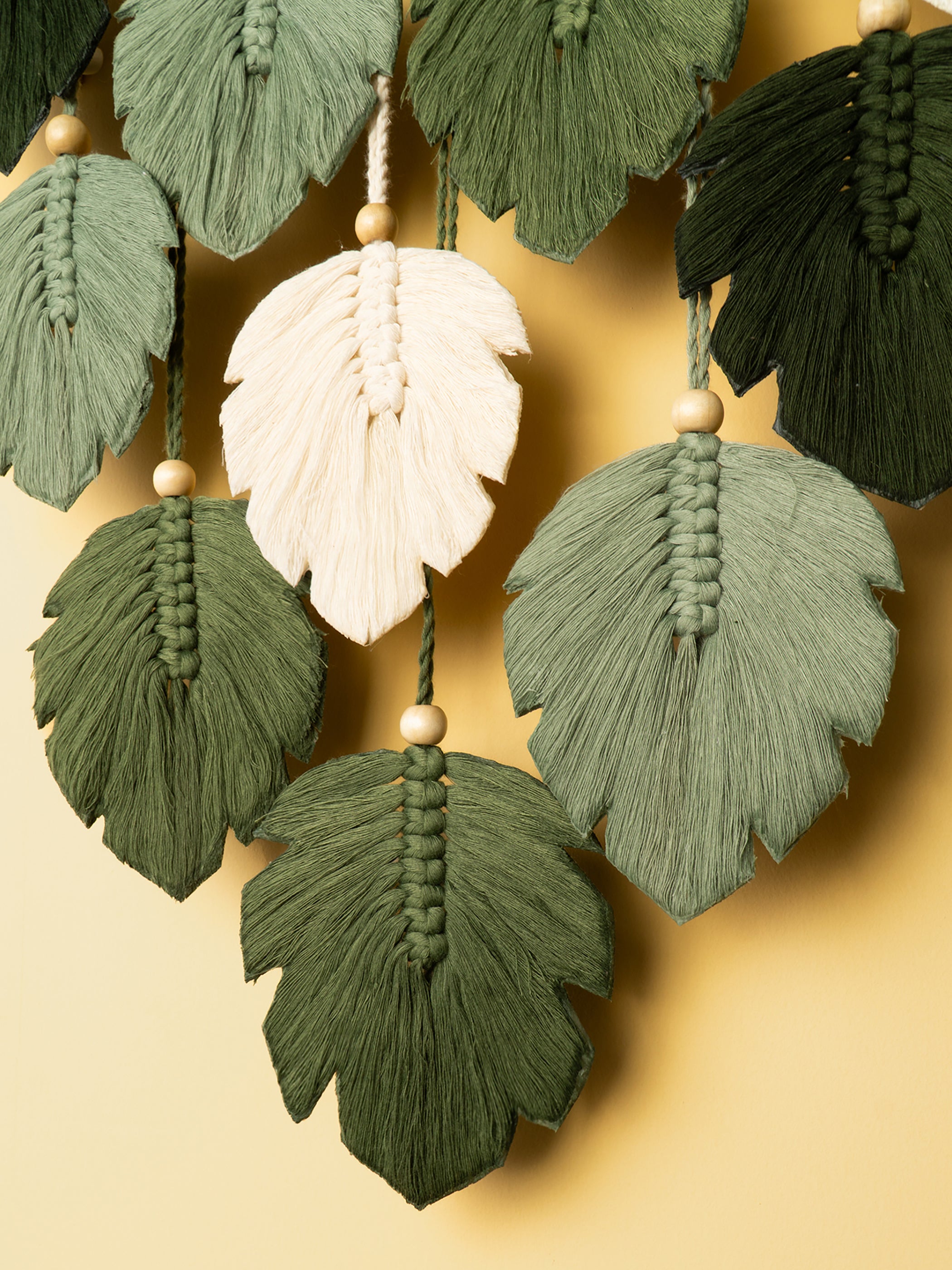 Decorative leaf tassel garland on a beige background