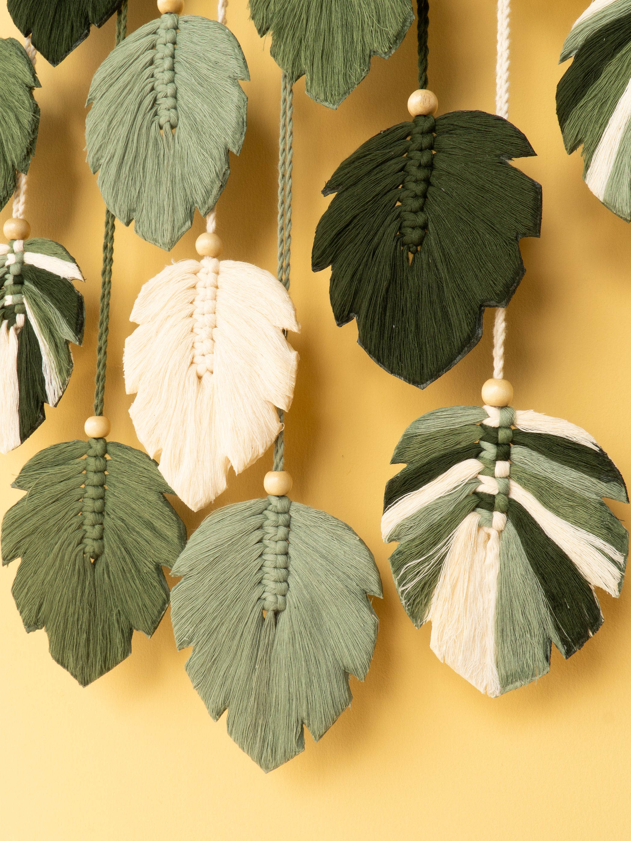 Decorative leaf-shaped tassels on a yellow background