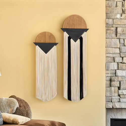 Two wall art pieces with wooden and fabric elements on a beige wall.