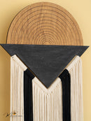 Decorative wall piece with wooden top and black triangular section on a beige background