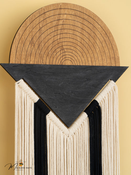 Decorative wall piece with wooden top and black triangular section on a beige background