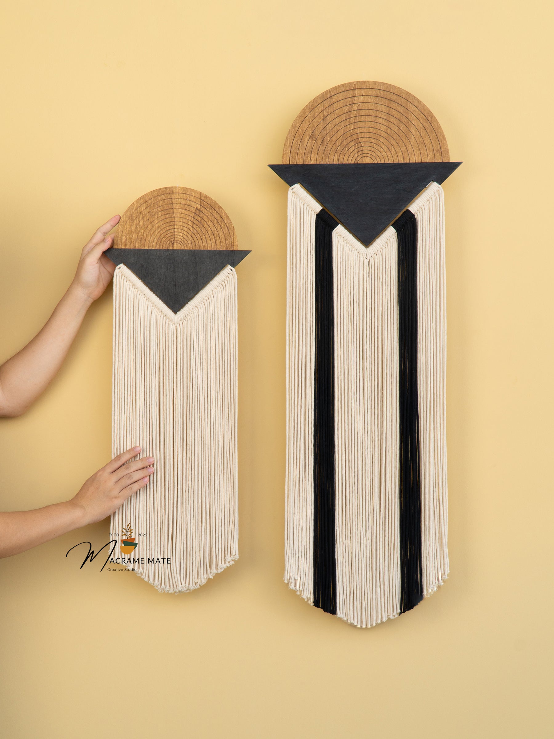 Two wall-mounted decorative items with geometric patterns on a yellow background