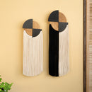 Two decorative wall art pieces with geometric designs on a beige wall.