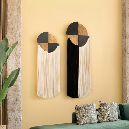 Two decorative wall mirrors with geometric design on a yellow wall.