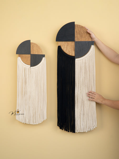 Two wall hangings with geometric designs and fringe on a beige background