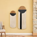 Two decorative wall hangings with circular designs on a yellow wall.