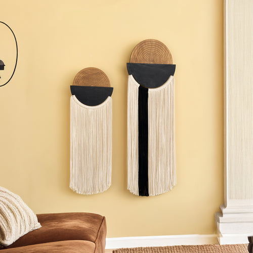 Two decorative wall hangings on a yellow wall with a brown sofa and white rug.